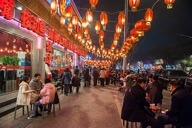 Chinese restaurants Beijing,China - March 31, 2011: People wait in front of Chinese restaurants at Gui street in Beijing,China.Most restaurants in the street are open all night. wangfujing stock pictures, royalty-free photos & images