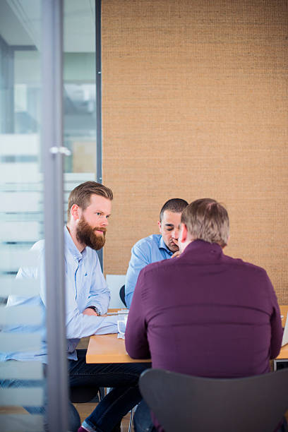 istock Businessmen discussing in board room 487049444