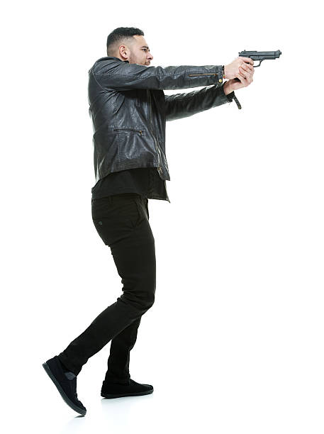 istock Casual man in action with handgun 487050258