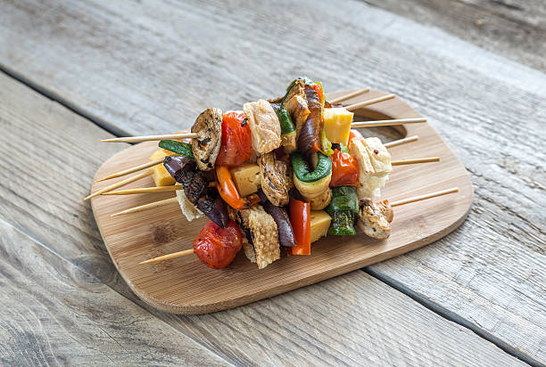 istock Grilled vegetable skewers on the wooden board 487050768