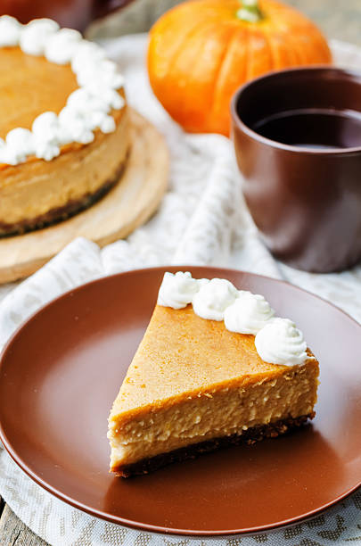 istock pumpkin cheesecake decorated with whipped cream 487051124