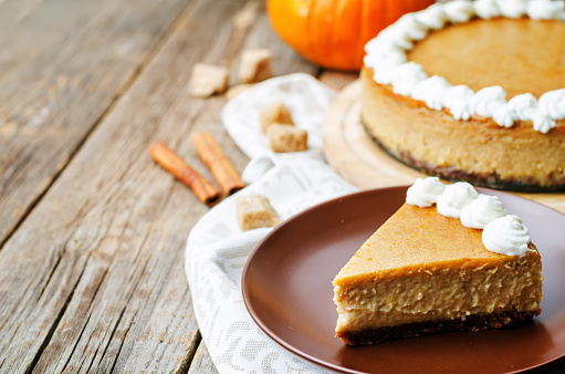 pumpkin cheesecake decorated with whipped cream. the toning. selective focus