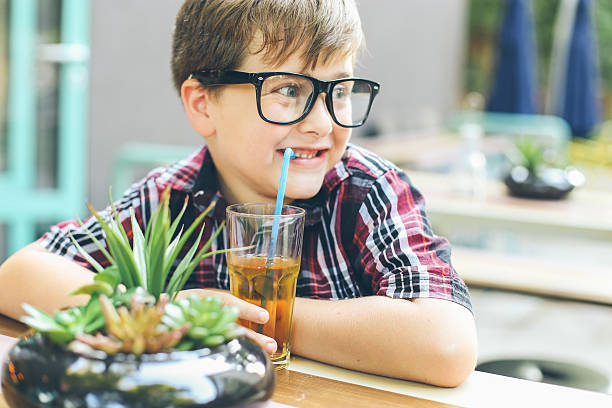 istock Happy little boy drinking soda drink 487053792
