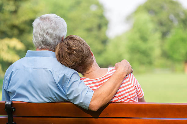 istock Senior adults outdoors in the park on park bench 487054230