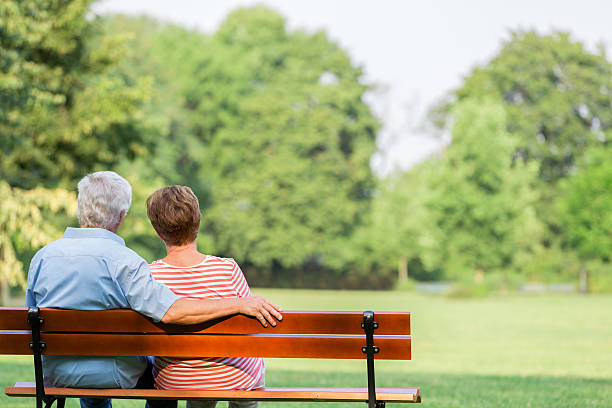istock Senior adults outdoors in the park on park bench 487054374