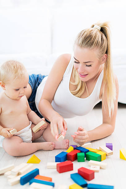 istock Mother and baby playing with blocks 487054618