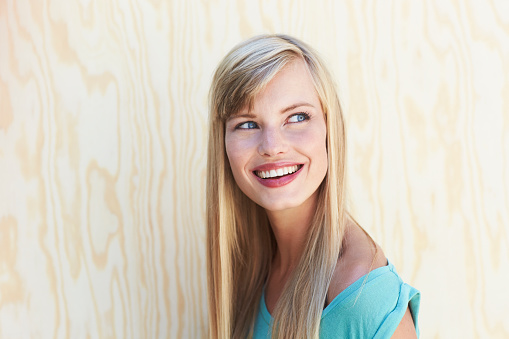 Gorgeous young woman smiling and looking over shoulder