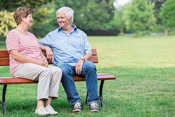 istock Senior adults outdoors in the park on park bench 487062884