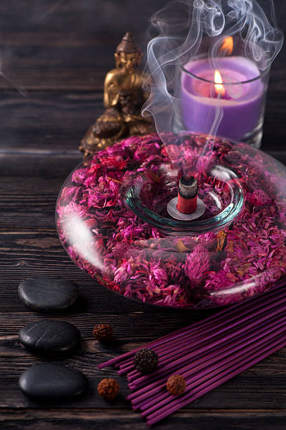istock Buddha statue, essential oils, incense sticks and stones zen 487063444