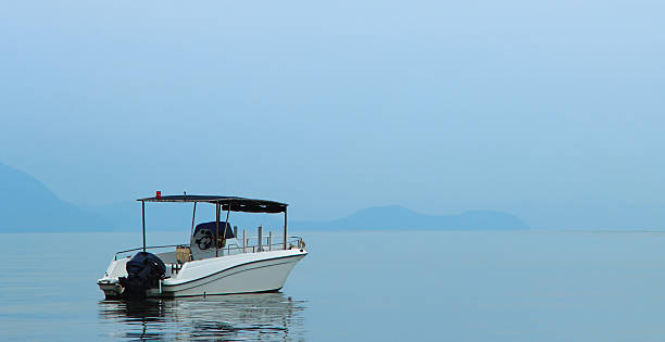 istock pleasure boat on a background haze 487064306