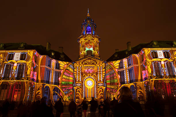 Rennes City Hall illuminated Rennes, France - December 22, 2014: Rennes City Hall the night in the street is illuminated with images projected in a free light and sound show. You can see lot of people in front. rennes france stock pictures, royalty-free photos & images