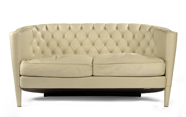 istock Antique retro sofa couch cream leather isolated on white 487066894