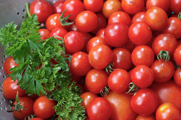 istock Close Up of Ripe Cherry Tomatoes and Parsley 487070810