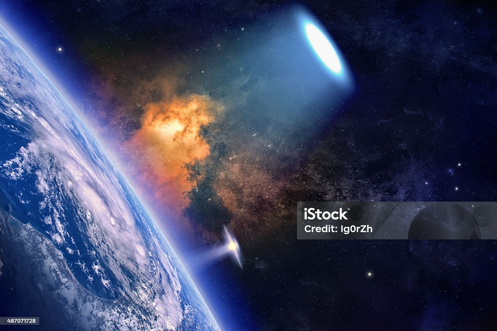 Ufo explores planet Earth Fantastic background - ufo with bright spotlight explores planet Earth in space, aliens invasion. Elements of this image furnished by NASA.  2015 Stock Photo