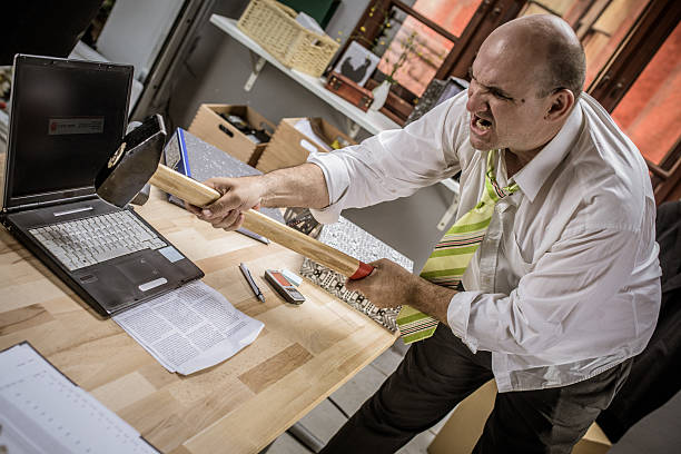 istock Businessman hitting hammer on laptop 487072298