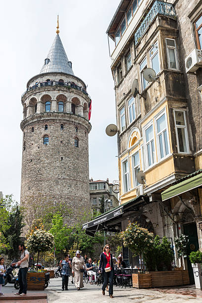 Istanbul, Turkey - April 23, 2014:Tourist near Galata tower in Istanbul, Turkey. The tower was built as Christea Turris in 1348 during an expansion of the Genoese colony in Constantinople. 