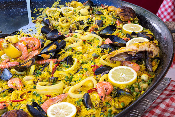 A big pan with fresh made paella at the market in Paris, France