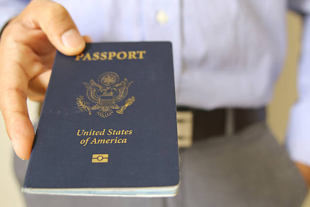 istock Hand Holding an American Passport Isolated 487077602