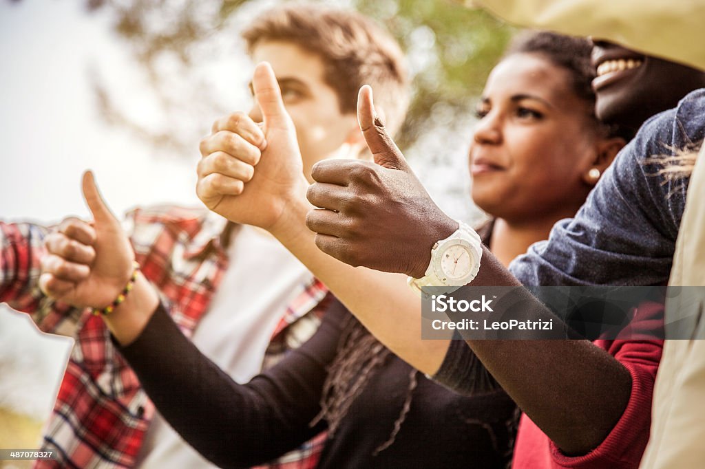 Group of teenagers showing thumbs up Group of teenagers showing thumbs up. 16-17 Years Stock Photo