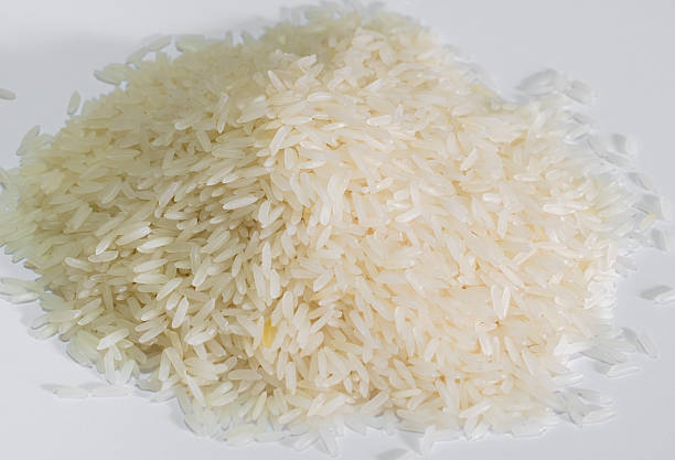 istock Jasmin rice on a pile on white background 487078720
