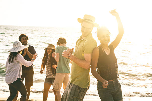 istock Group of multi-ethnic friends dancing on the beach 487080033