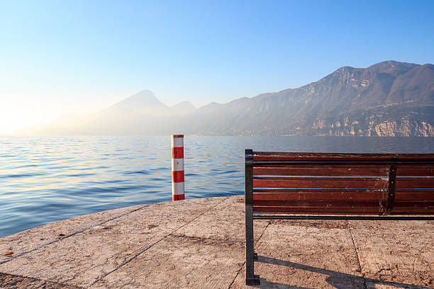 bench enviting to sit down watching sunset bench enviting to sit down watching sunset on mountains lake enviting stock pictures, royalty-free photos & images