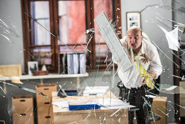 istock Businessman throwing keyboard on glass 487081434