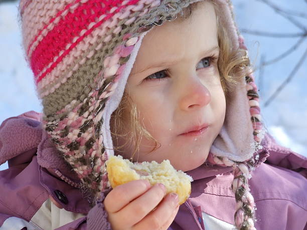 Sweet little girl in a outdoor shadowy portrait from the mouth up. Her eyes look up to the heavens. A blue, blue sky above her.