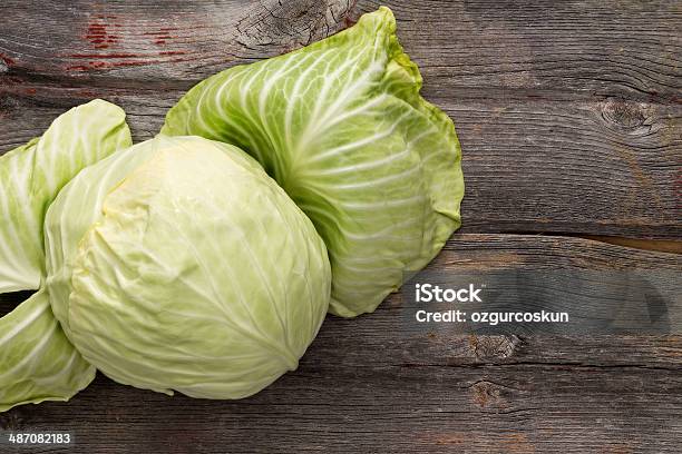 Fresh Green Cabbage On A Wooden Table Stock Photo - Download Image Now - Cabbage, Biology, Calcium