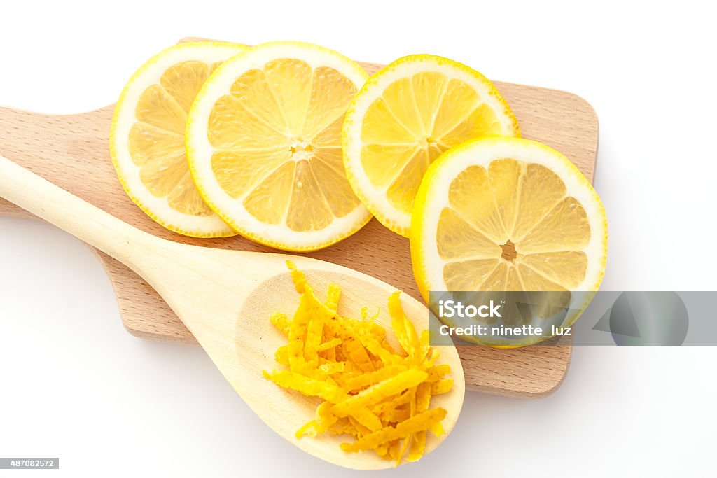 Lemon circles and lemon zest Lemon zest and sliced lemons on a cutting boards, ingredients for a dessert 2015 Stock Photo