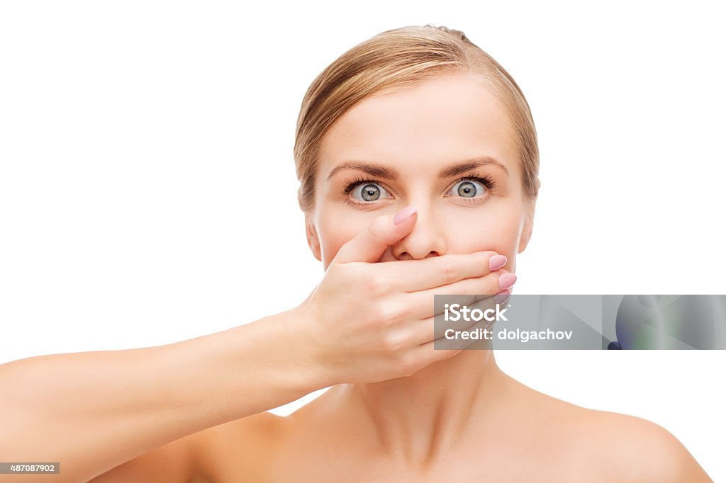 young woman doing hush gesrute health and beauty concept - clean face of beautiful young woman covering her mouth with hand Bad Breath Stock Photo