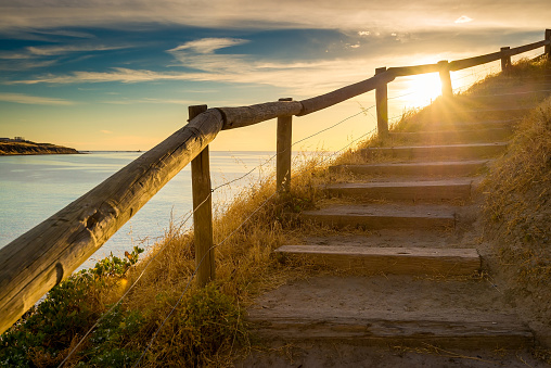 Stairs up on the hill with sunset flares