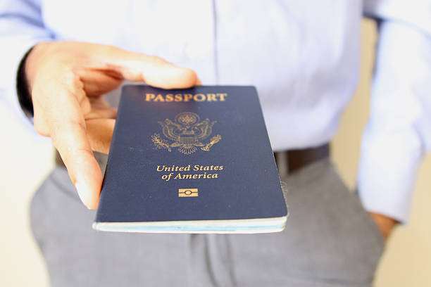 istock Image of a persons hand holding a passport 487091524