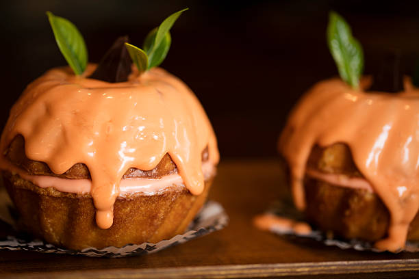 Mini orange bundt cakes for a Halloween party celebration with orange cream glaze and cream cheese frosting