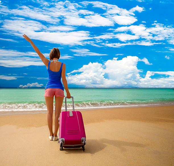 istock Beautiful girl with bag in a beach 487098225