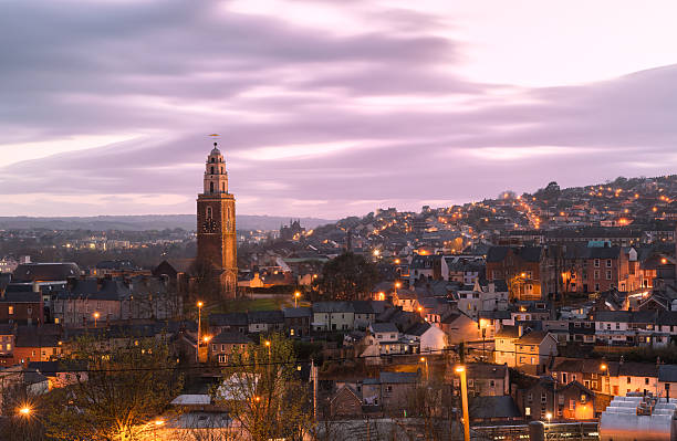 St. Anne's Church, Shandon, Cork Cork, Ireland - April 12, 2014: St. Anne's in Shandon and the City of Cork photographed against a beautiful sunset at dusk. county cork stock pictures, royalty-free photos & images