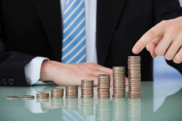 istock Businessman With Coins Stacked As Bar Graph 487099710