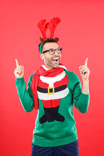 istock Excited nerd man in funny winter outfit against red background 487100124
