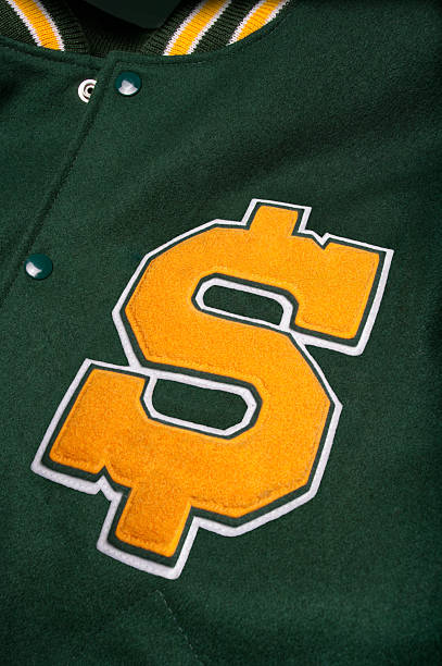Dollar sign lettermans jacket Letterman jacket with a dollar symbol. Symbolizing the high cost of high school and college sports and athletics. embroidery photos stock pictures, royalty-free photos & images