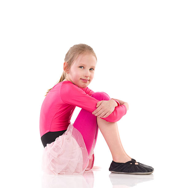 istock Little girl sitting on the floor, Side view. 487100905