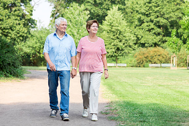 istock Happy senior couple walking outdoors in the park 487100954
