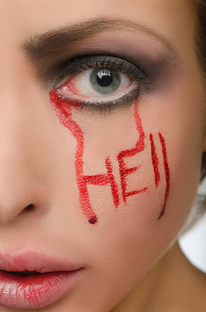 istock Female face with inscription hell blood 487102215