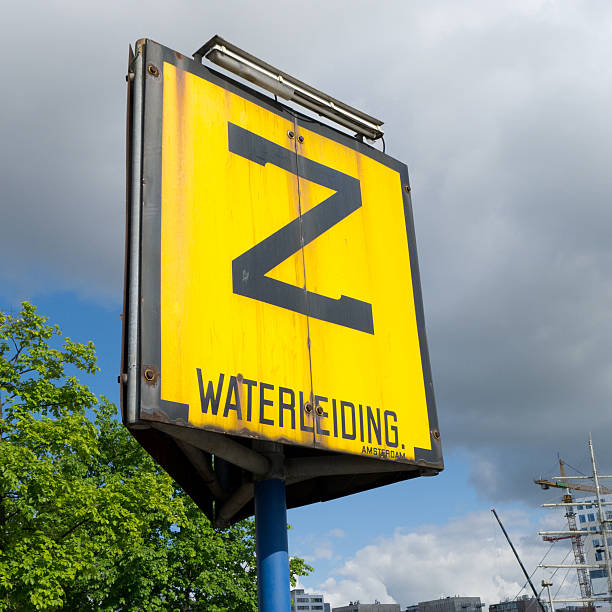 A large yellow sign in Amsterdam, Holland, indicatting the location of an underwater pipe, a so called zinker.