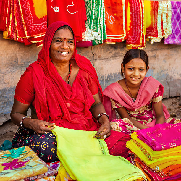 istock Indian women selling colorful fabrics 487104834