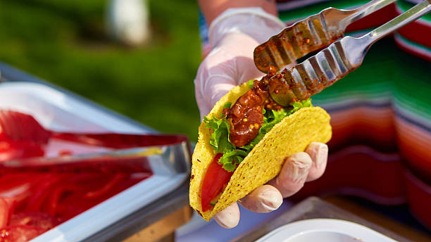 istock Chef making tacos at a street cafe 487107434