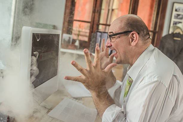 Frustrated businessman looking at computer screen Frustrated businessman looking at computer screen and shouting in office, emitting smoke from besides. coming out of computer screen stock pictures, royalty-free photos & images