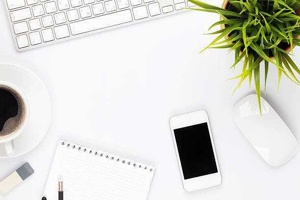 istock Office desk table with computer, supplies, flower and coffee cup 487109090