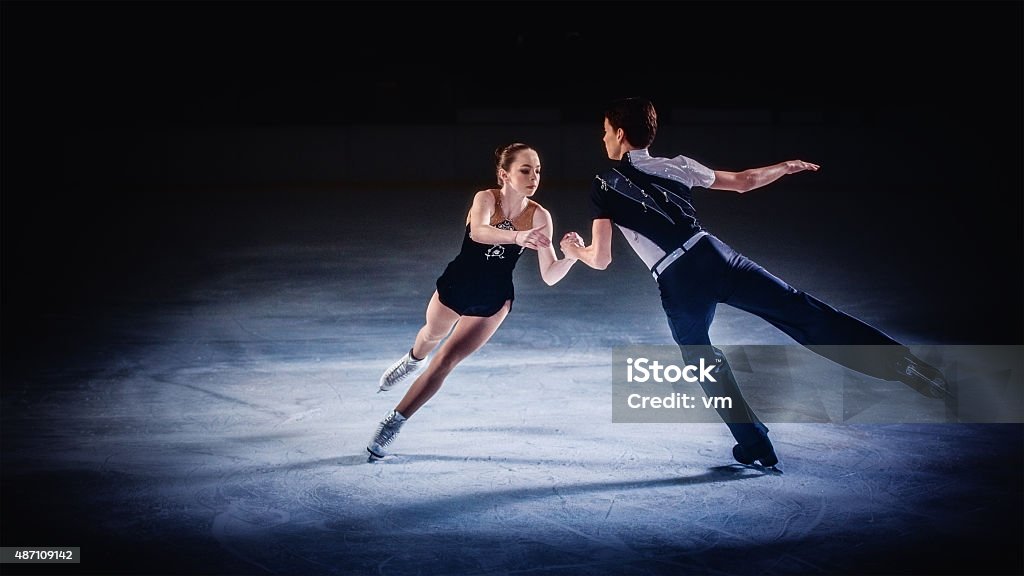 Figure skating pair performing Male and female figure skaters performing. Figure Skating Stock Photo
