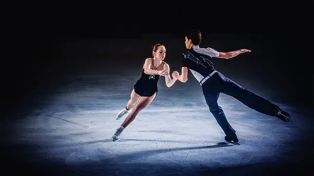 Male and female figure skaters performing.