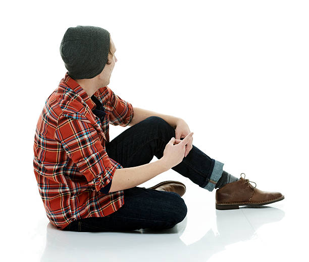 istock Hipster sitting on floor and looking away 487109538
